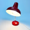 Red table lamp in good condition, minimal user marks appropriate to its age. Lacquer still in very good condition! Bendable piece so the shade is adjustable and can be used as desired. The dimensions are: height 43 cm - diameter cap 18 cm